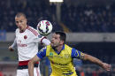 Chievo's Sergio Pellissier, right, is challenged by AC Milan's Salvatore Bocchetti, bottom, and his teammate Luca Antonelli during a Serie A soccer match at Bentegodi stadium in Verona, Italy, Saturday, Feb. 28, 2015. (AP Photo/Felice Calabro')