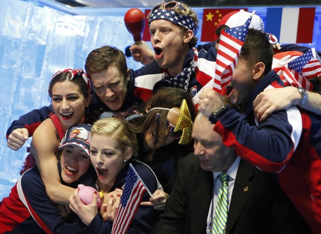 Gracie Gold of the U.S. and her teammates react after the announcement of her performance result during the women's free skating at the ISU World Team Trophy in Figure Skating, in Tokyo