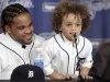 Jadyn Fielder, 7, answers a question next to his father, Prince Fielder, who agreed to a $214 million, nine-year contract with the Detroit Tigers, during his introduction to reporters as a member of the team at a baseball news conference at Comerica Park in Detroit, Thursday, Jan. 26, 2012. (AP Photo/Carlos Osorio)