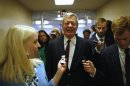 U.S. Senator Baucus talks to reporters after the Senate passed a spending bill to avoid a government shutdown at the U.S. Capitol in Washington