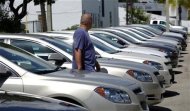 <p>A man walks next to Chevrolet vehicles at a GM dealership in Miami, Florida August 12, 2010. REUTERS/Carlos Barria</p>