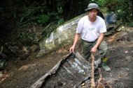 Handout photo from the Malaya Historical Group shows group leader Shaharom Ahmad at the crash site of a B-24 Liberator KL654/R aircraft in Malaysia's Negri Sembilan. Shaharom and his friends are aviation and battlefield buffs who locate and identify the remains of WWII aircraft that have remained missing for the last six decades