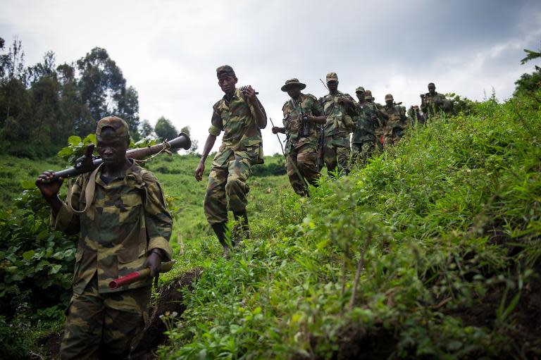 M23 rebels withdraw through the hills having left their position in the village of Karuba, eastern Democratic Republic of Congo, on November 30, 2012