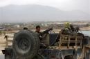 Afghan National Army soldiers keep watch near the site of a gunfight on the outskirts of Kabul