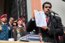 Venezuelan President Nicolas Maduro shows the books with the national budget for 2017 at the National Pantheon in Caracas, on October 14, 2016