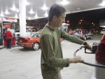 Lyndon Fong of Honolulu fills up his gas tank after learning of a tsunami waring Saturday, Oct. 27, 2012, in Honolulu. A tsunami warning has been issued for Hawaii after a 7.7-magnitude earthquake rocked an island off the west coast of Canada. The Pacific Tsunami Warning Center originally said there was no threat to the islands, but a warning was issued later Saturday and remains in effect until 7 p.m. Sunday. A small craft advisory is in effect until Sunday morning.(AP Photo/Eugene Tanner)