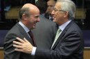 Spain's Economy Minister de Guindos talks with his Luxembourg counterpart Juncker during a meeting ahead of a eurozone finance ministers meeting in Luxembourg