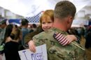 A child hugs his father, who returned from Afghanistan on Nov. 4, 2012, after a nine-month deployment.