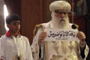 Egyptian caretaker of the Coptic Church, interim Pope Bakhomious holds a piece of paper with the name of Bishop Tawadros written on it in Cairo