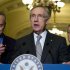 Reid stands with Schumer and Durbin as he talks to reporters about the senate's vote on debt ceiling legislation at the U.S. Capitol in Washington