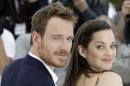 Actors Michael Fassbender, left, and Marion Cotillard pose for photographers during a photo call for the film Macbeth, at the 68th international film festival, Cannes, southern France, Saturday, May 23, 2015. (AP Photo/Lionel Cironneau)