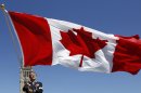 Triathlete Simon Whitfield waves the Canadian flag after being named Canada's flag bearer for the opening ceremony at the London 2012 Olympic Games, on Parliament Hill in Ottawa