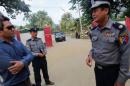 Policemen stand in front of the border guard headquarters at Kyee Kan Pyin village outside Maungdaw