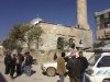 Residents are seen near a damaged mosque after heavy shelling by government forces in Sermeen, near the northern city of Idlib