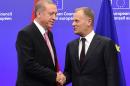 Turkey's President Recep Tayyip Erdogan (left) is welcomed by European Council President Donald Tusk in Brussels, on October 5, 2015