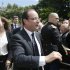 France's President Hollande and his companion Trierweiler shake hands with visitors in the gardens of the Elysee Palace in Paris