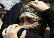 Family members of Pakistani acid attack victim Fakhra Younnus, mourn her death at Karachi airport in Pakistan on Sunday, March 25, 2012. Fakhra who committed suicide by jumping from the sixth floor of her flat in Rome, was a victim of an acid attack allegedly carried out 12 years ago by her husband, the son of a feudal politician. (AP Photo)