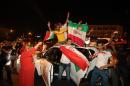 Iran's fans show off their national flag as they celebrate on Vanak Square, in the capital Tehran, on June 21, 2014, despite their national team'a narrow defeat to Argentina in the FIFA 2014 World Cup in Brazil
