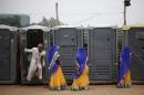 A groom comes out from a toilet as brides stand at the venue for a mass wedding ceremony at Ramlila ground in New Delhi
