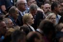 New York City Mayor Bill de Blasio speaks to US Democratic presidential nominee Hillary Clinton during a memorial service at the National 9/11 Memorial in New York on September 11, 2016