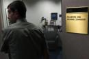 A man walks past a doorway at the Fort Worth Regional Office of the SEC in Fort Worth