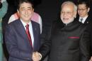 India's Prime Minister Narendra Modi shakes hands with Japan's Prime Minister Shinzo Abe upon his arrival in Kyoto, western Japan