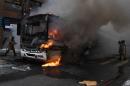 Civil servants protesting against austerity measures clash with riot police and set fire to a bus on Rio Branco, the main avenue in Rio de Janeiro, Brazil, while firefighters attempt to put out the blaze, on February 1, 2017