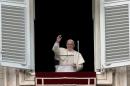 Pope Francis waves to worshippers gathered in St.Peter's Square at the Vatican on January 12, 2014