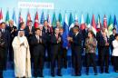 Members of G20 applaud after traditional family photo during the G20 leaders summit in Antalya