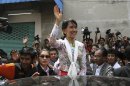 Myanmar opposition leader Aung San Suu Kyi waves while leaving a community center in Mahachai, Samut Sakhon Province, Thailand on Wednesday, May 30, 2012. Kicking off her first trip abroad in nearly a quarter-century, Suu Kyi offered encouragement Wednesday to impoverished Myanmar migrants whose flight to neighboring Thailand is emblematic of the devastation wrought on her homeland by decades of misrule.(AP photo/Sakchai Lalit)