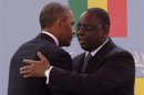 U.S. President Obama and Senegal President Sall embrace after their joint news conference at Presidential Palace in Dakar
