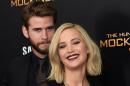 Jennifer Lawrence and Liam Hemsworth, pictured November 18, 2015 in New York, could not propel "The Hunger Games: Mockingjay, Part 2" to overtake the earnings of it's predecessor