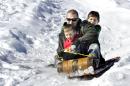 Josh Davis, Bloomsburg, Pa., and his sons Kaden, front, 5, and Cole, 8, ride a toboggan downhill at Josh's cousin Barry J. Davis' home near Bloomsburg, Pa., on Monday, Feb. 17, 2014. Josh and Barry constructed the downhill toboggan run for their boys to enjoy on the Presidents Day holiday. (AP Photo/Bloomsburg Press Enterprise, Bill Hughes)