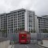 A double decker bus drives past the Olympic Village before the start of the 2012 Summer Olympics, Monday, July 16, 2012, in London. (AP Photo/Jae Hong)
