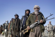 Former Taliban militants hold their weapons during a joining ceremony with the Afghan government in Herat, west of Kabul, Afghanistan, Monday Jan. 30, 2012. Mullah Abdullah, not pictured, a Taliban militant commander from Herat province joined with Afghan government along with his 30 militants under his command and handed over their weapons as part of a peace-reconciliation program. (AP Photo/Hoshang Hashimi)
