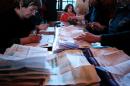 Volunteers count the ballots at the end of the first round of the French municipal elections on March 23, 2014, at a polling station in Rouen