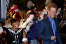 Britain's Prince Harry, right, walks past a samba drumer upon his arrival at the Sugar Loaf mountain cable car station in Rio de Janeiro, Brazil, Friday March 9, 2012. Harry is in Brazil at the request of the British government on a trip to promote ties and emphasize the transition from the upcoming 2012 London Games to the 2016 Olympics in Rio de Janeiro. (AP Photo/Victor R. Caivano)