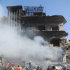 In this photo released by the Syrian official news agency SANA, Syrian army soldiers and security officers inspect the blast area in front of a damaged building of the air intelligence forces, which was attacked by one of two explosions, in Damascus, Syria, on Saturday, March 17, 2012. Two "terrorist explosions" struck security targets in the Syrian capital Saturday morning, killing a number of civilians and security forces, the country's state news agency said. The report said preliminary reports indicated they blasts were caused by car bombs that hit the aviation intelligence department and the criminal security department. (AP Photo/SANA)