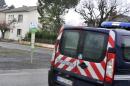 A police vehicle is parked near a house of an alleged jihadist fighter in Graulhet, southwestern France, on December 15, 2014