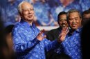 Malaysia's Prime Minister Najib Razak and his deputy Muhyiddin Yassin share a light moment after winning the elections at his party headquarters in Kuala Lumpur