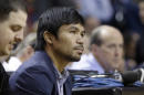 FILE - In this Jan. 27, 2015 file photo, boxer Manny Pacquiao watches the game between the Miami Heat and the Milwaukee Bucks during the first half of an NBA basketball game in Miami. HBO and Showtime have agreed on how they would broadcast a fight between Floyd Mayweather Jr. and Manny Pacquiao, promoter Bob Arum said Thursday, Feb. 5, 2015, leaving only two remaining issues to be settled before the much anticipated May 2 fight can be signed. (AP Photo/Alan Diaz)