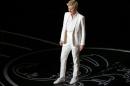 Host Degeneres stands on stage at the 86th Academy Awards in Hollywood