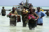 Tanzanian police carry bodies of children from the sea in Zanzibar, Tanzania, Saturday, Sept 10, 2011. An overcrowded ship sank in deep sea off mainland Tanzania on Saturday with about 600 people onboard, and about 370 people are believed missing or dead. (AP Photo/Sultan Ali)
