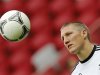 Germany's national soccer player Schweinsteiger looks at the ball during a training session at the stadium in Warsaw