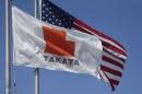 A flag with the Takata logo flies alongside a U.S. flag outside Takata corporation in Auburn Hills, Michigan