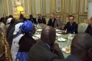 French President Francois Hollande speaks with members of Malian associations in France during a meeting at the Elysee Palace in Paris