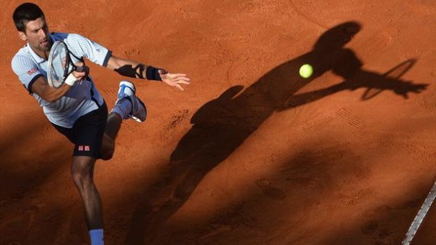 Novak Djokovic of Serbia returns the ball to Albert Montanes of Spain (AFP)