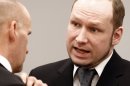 Defendant Anders Behring Breivik talks with defence lawyer Geir Lippestad, left, in court prior to the opening of day 6 of the trial in Oslo, Monday April 23, 2012. Breivik has admitted setting off a car bomb outside the government headquarters, killing eight, before unleashing a shooting massacre at the governing Labor Party's youth camp on Utoya. (AP Photo/Lise Aserud, POOL)