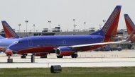 FILE - In this April 6, 2011 file photo, a Southwest Airlines aircraft taxies at Philadelphia International Airport, in Philadelphia. Southwest Airlines is making money Thursday, Jan. 19, 2012, even with higher fuel prices, thanks to full planes and rising fares. (AP Photo/ Joseph Kaczmarek, File)