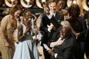 Director and producer McQueen celebrates after accepting the Oscar for best picture with Nyong'o at the 86th Academy Awards in Hollywood
